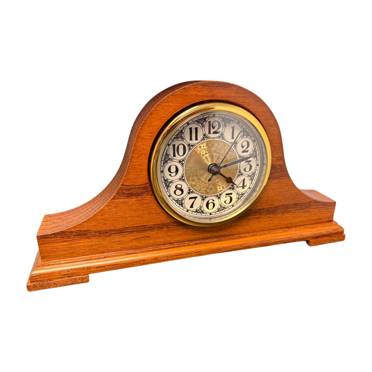 Solid oak tambour desk clock, three-quarter view showing the arched case