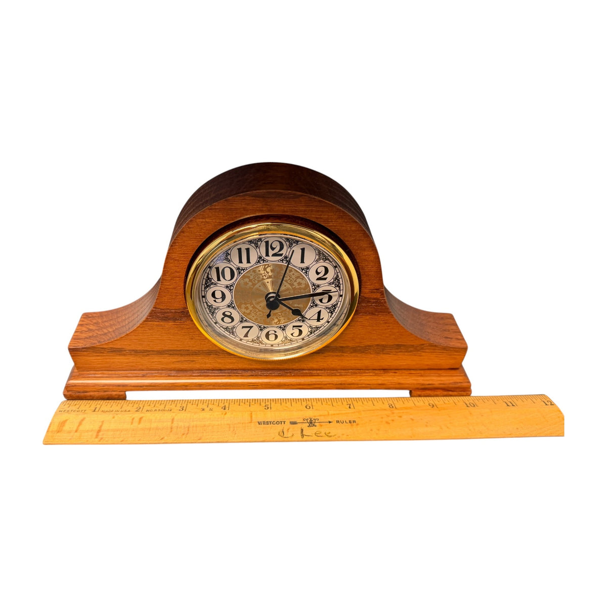 Oak tambour desk clock shown beside a ruler for size reference